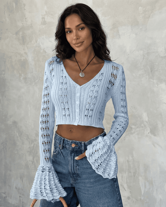 Azure Cardigan by Slimona, cropped cotton knit with flare sleeves, showcasing a soft blue color and unique hollow-out detailing.