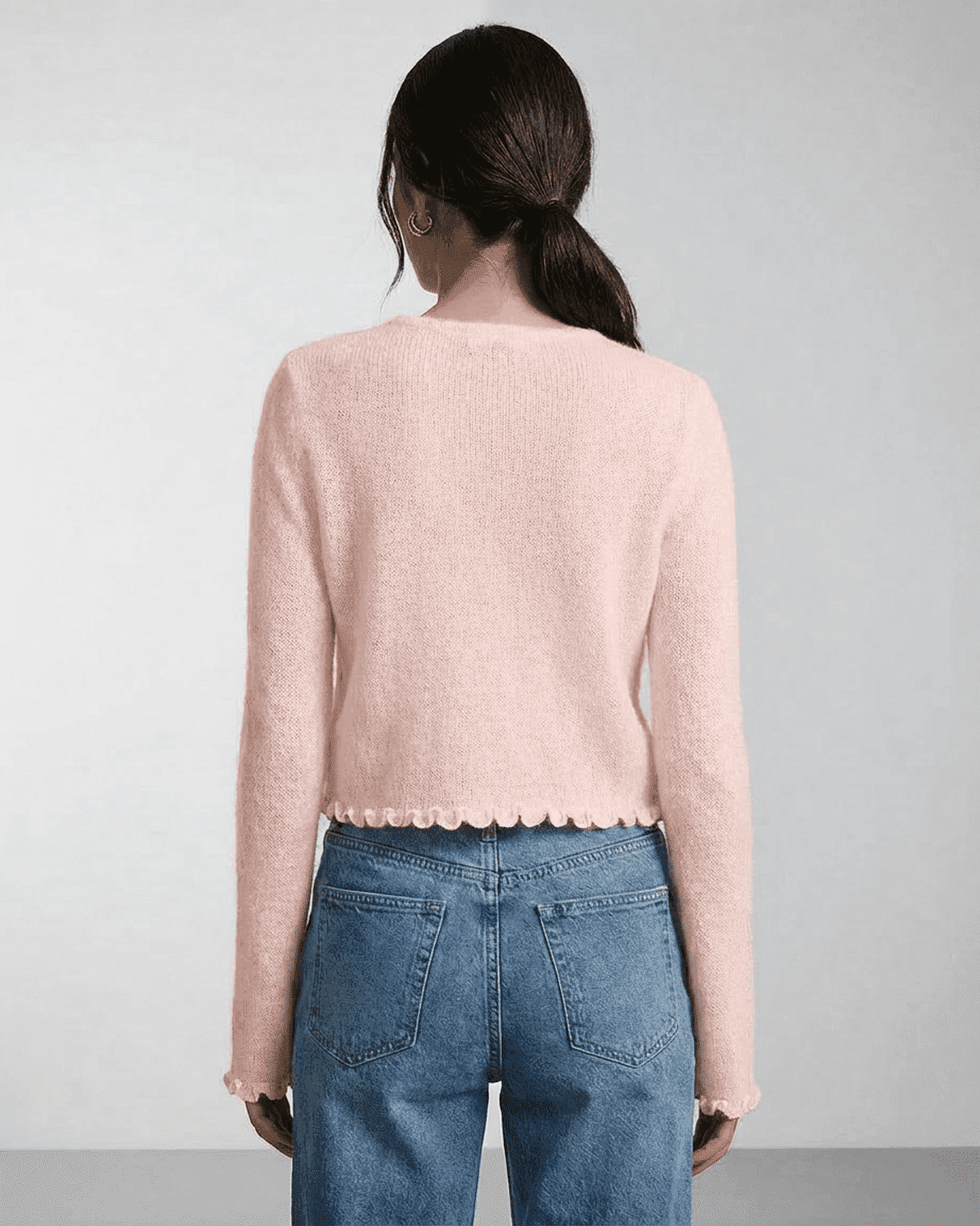 Blush Cardigan by Slimona, showcasing the back view of a soft pink knit cardigan with scalloped edges.