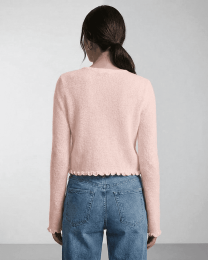 Blush Cardigan by Slimona, showcasing the back view of a soft pink knit cardigan with scalloped edges.