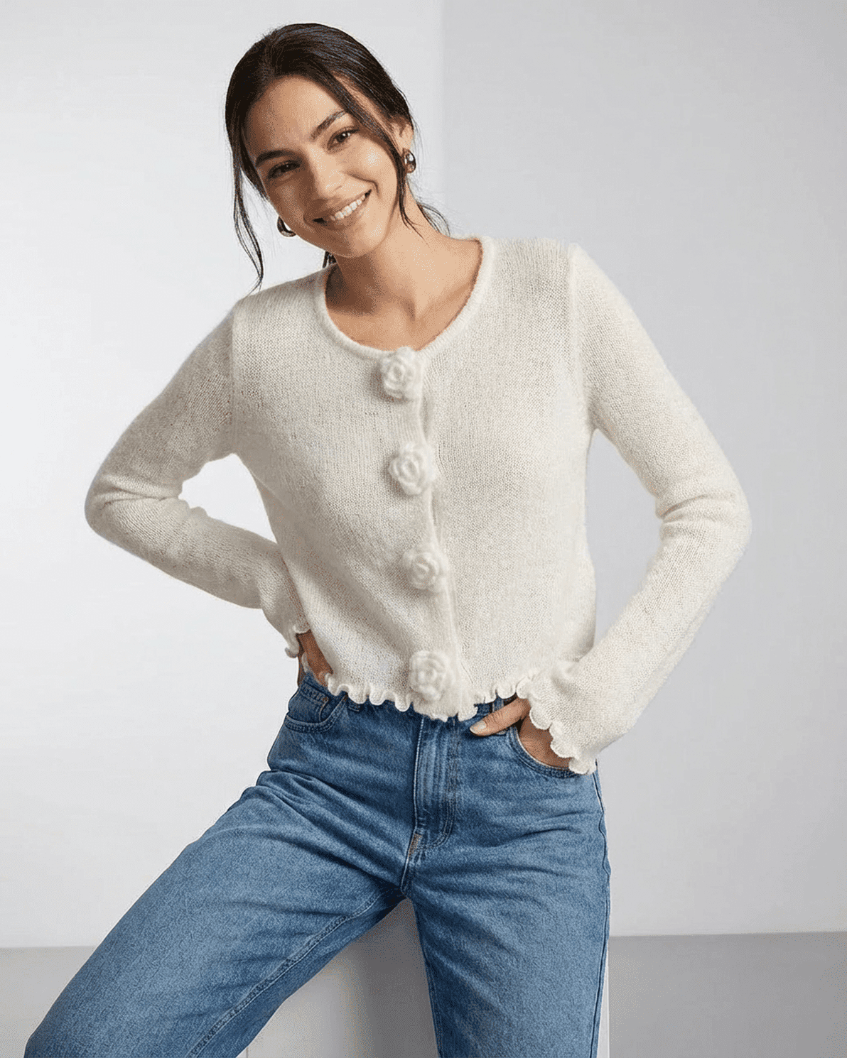 Woman wearing the Slimona Camellia Cardigan with floral buttons and a soft knit texture.