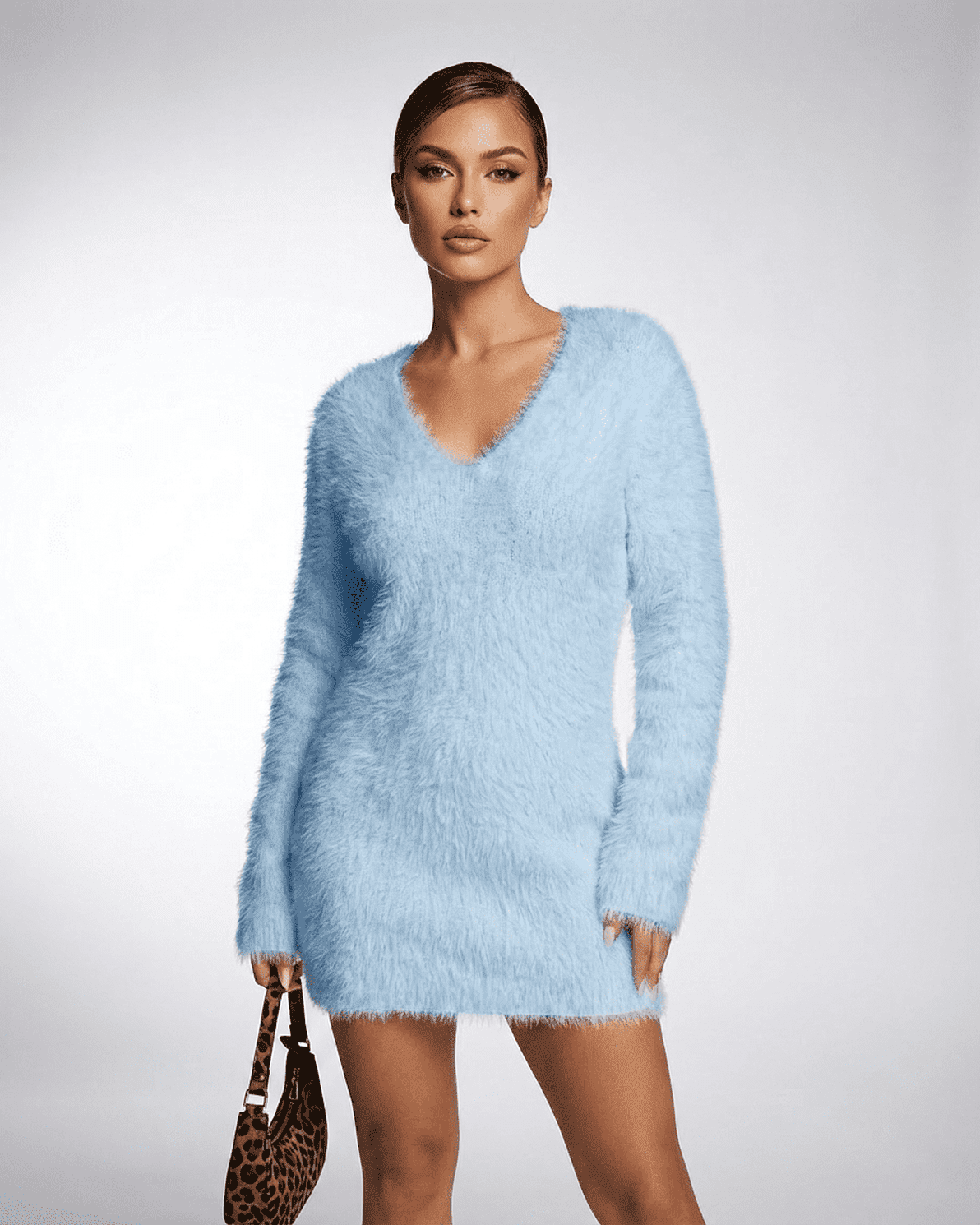 Celeste Sweater by Slimona in soft blue, featuring a V-neck and plush knit texture for cozy fall styling.