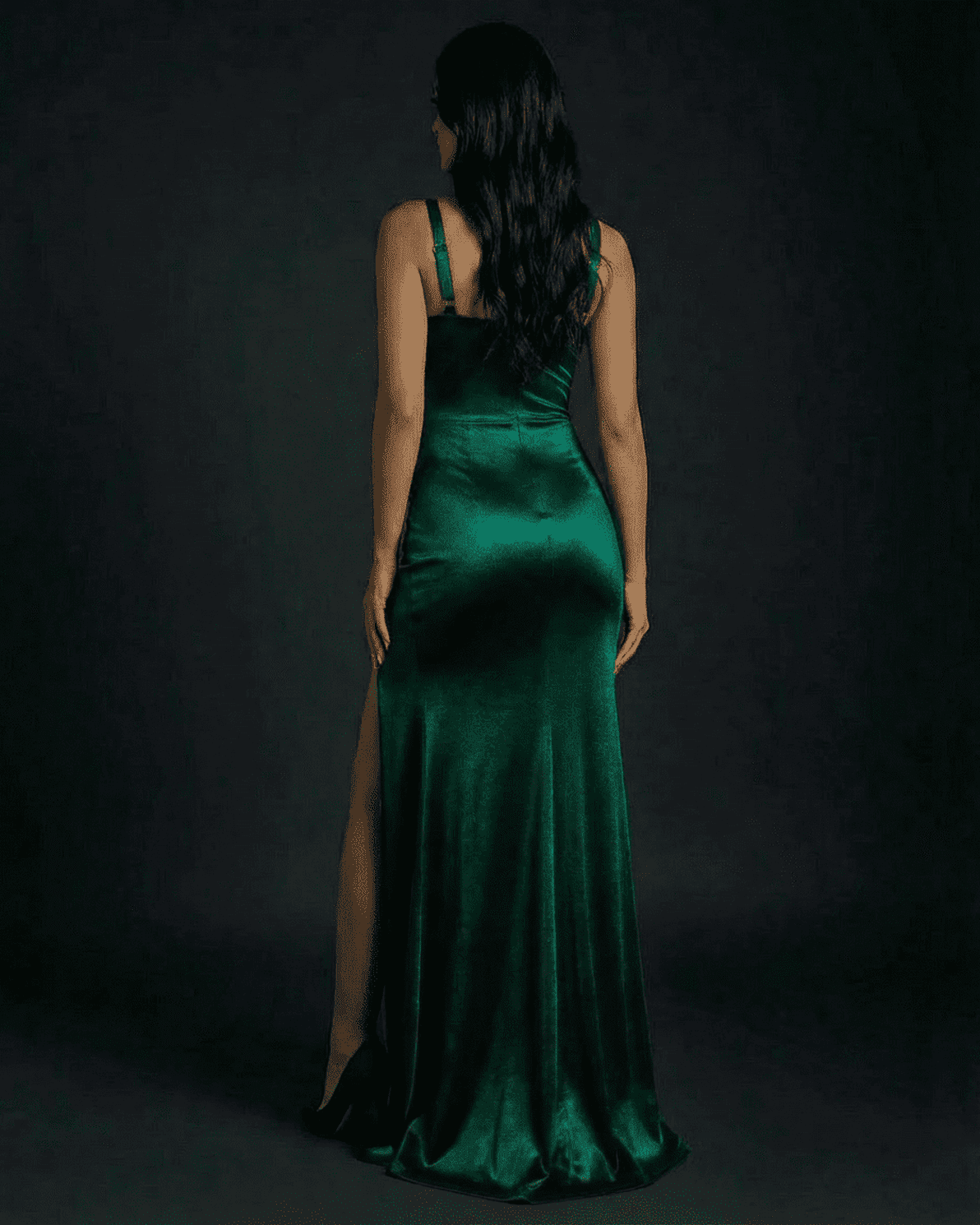 Celestine Maxi Dress by Slimona, elegant emerald green satin bodycon dress with high slit, seen from the back.
