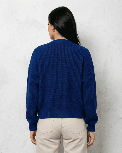 Back view of a woman wearing the Cobalt Cardigan from Slimona in a vibrant blue knit fabric.