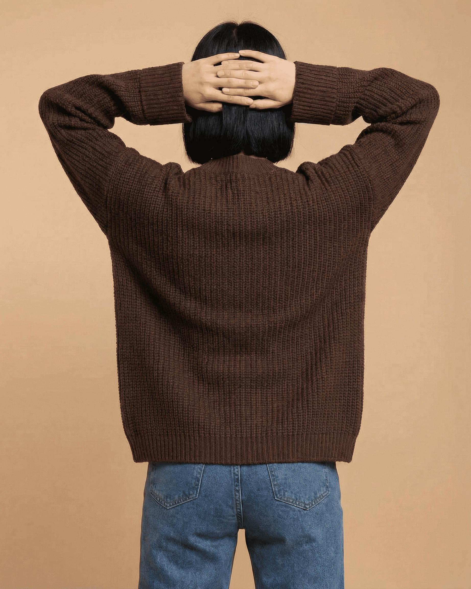 Back view of a model wearing the Cocoa Cardigan by Slimona, showcasing the relaxed fit and knit texture.