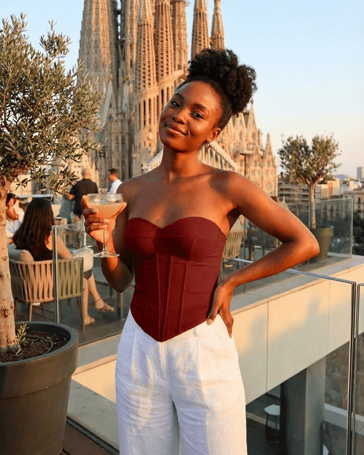 Model showcasing the Crimson Corset Top by Slimona, featuring faux denim bustier design and structured fit.