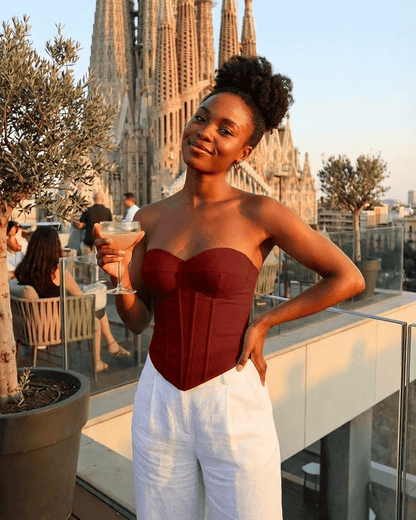 Model showcasing the Crimson Corset Top by Slimona, featuring faux denim bustier design and structured fit.