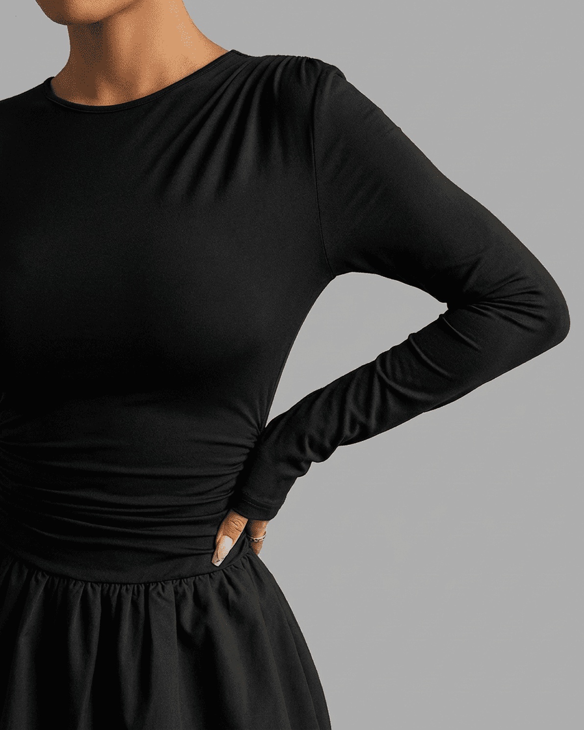 Detail of the Elara Mini Dress by Slimona, featuring fitted long sleeves and a cinched waist design.