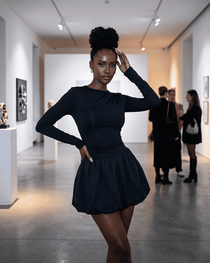 Elara Mini Dress by Slimona showcased in a fashion event, featuring a fitted stretchy silhouette and elegant tiered skirt.