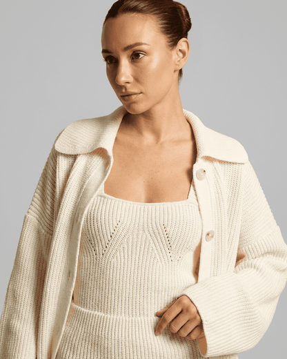 Elysia Mini Dress styled with a chic white knit cardigan from Slimona, highlighting a modern, sophisticated look.