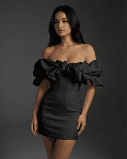 Elysia Mini Dress by Slimona featuring a dramatic off-the-shoulder silhouette and voluminous ruffle trim in black.
