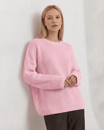 Fiora Sweater by Slimona in soft pink, showcasing a loose fit, thick ribbed knit, and round neckline for cozy autumn wear.