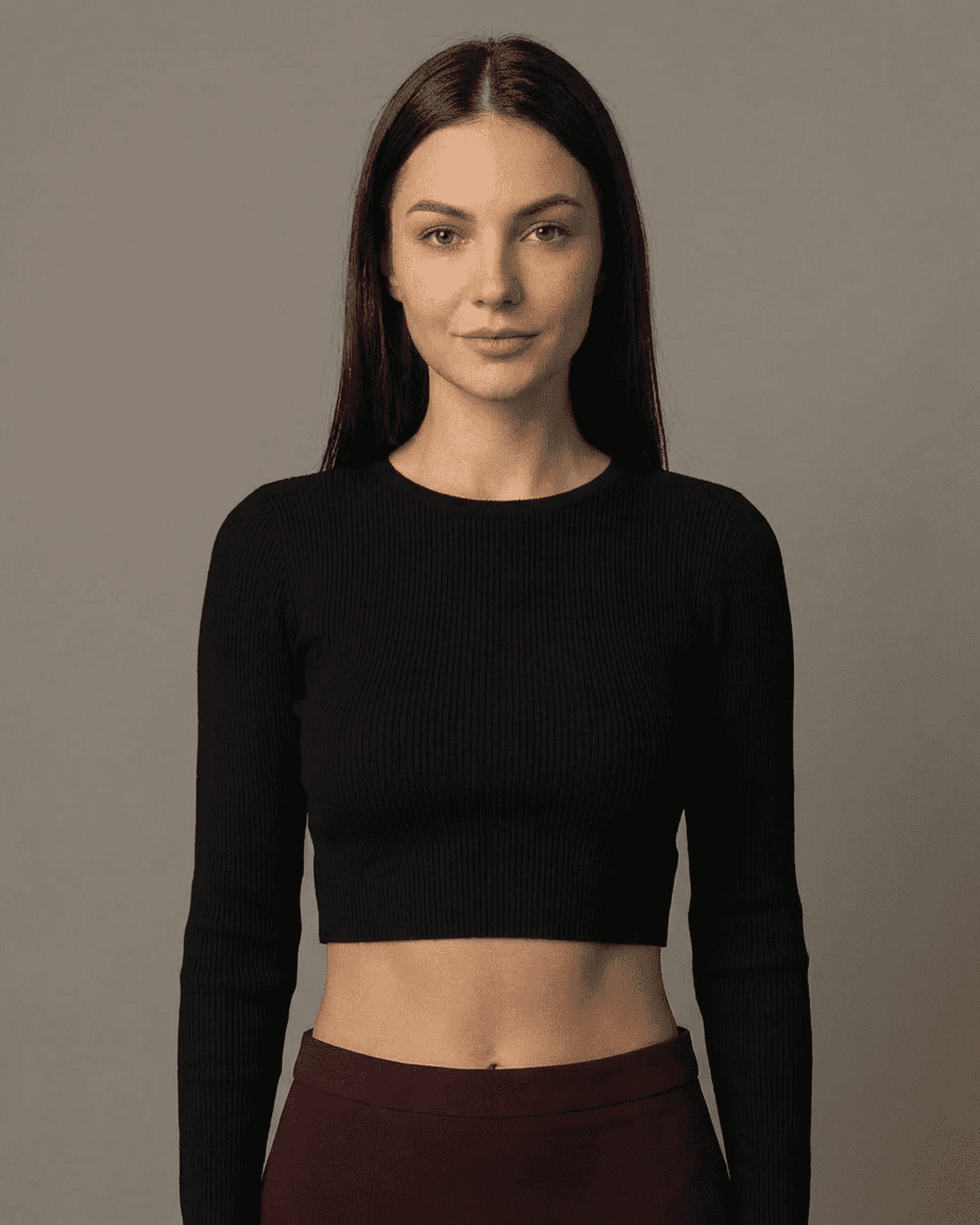 Model wearing a black cropped top, showcasing a sleek style perfect for layering with the Merlot Maxi Skirt.