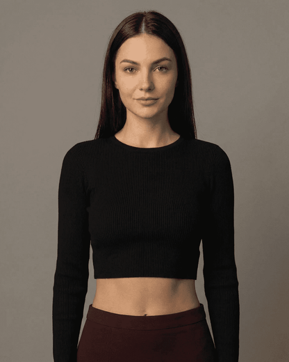 Model wearing a black cropped top, showcasing a sleek style perfect for layering with the Merlot Maxi Skirt.