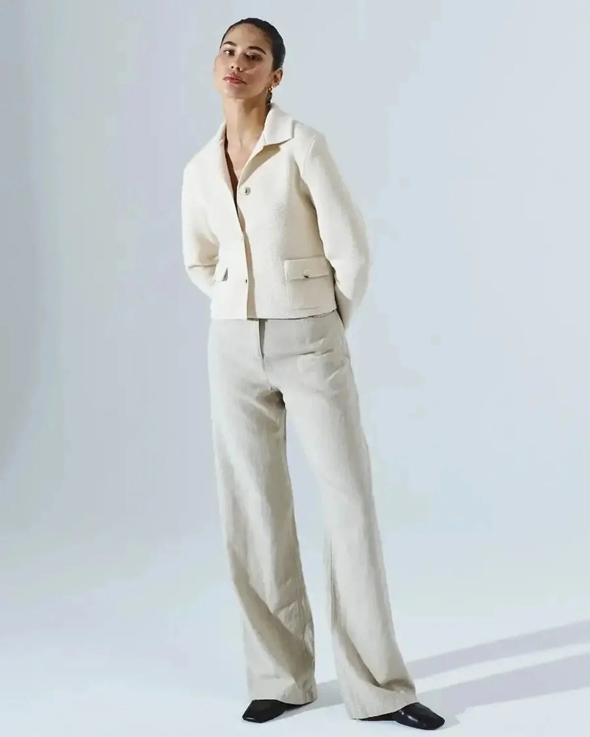 Lazio Cropped Jacket worn by a model, showcasing elegant cream design from Slimona brand, perfect for stylish occasions.