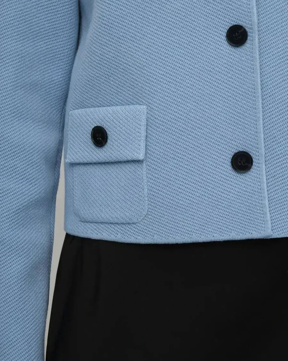 Lazio Jacket by Slimona - cropped light blue women's jacket with button closure and front pocket detail.