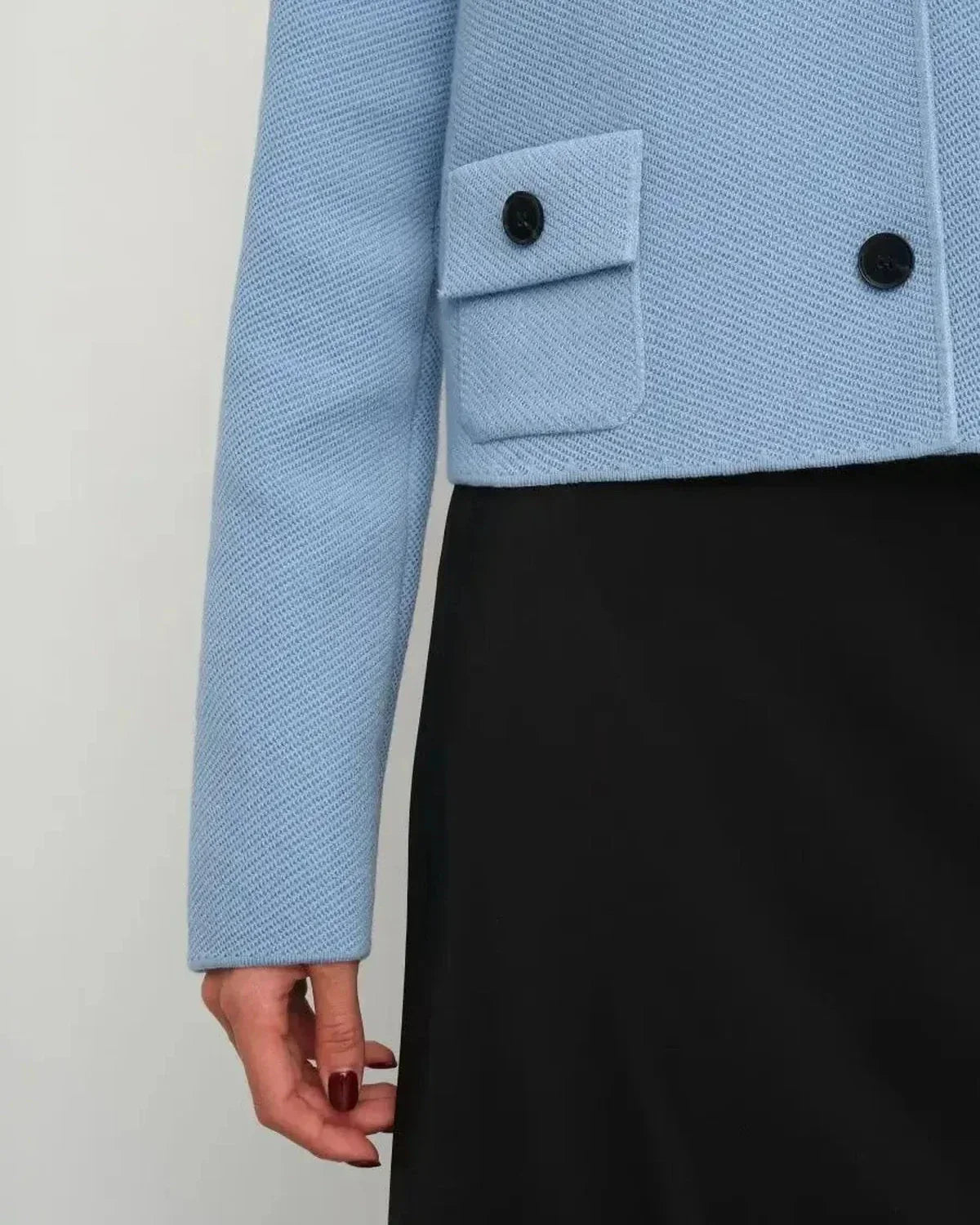 Lazio Jacket by Slimona, cropped light blue women's jacket with button closure and pocket detail.