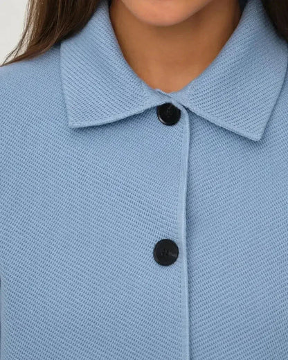 Lazio Jacket by Slimona - Light blue cropped women's jacket with button closure and textured fabric.