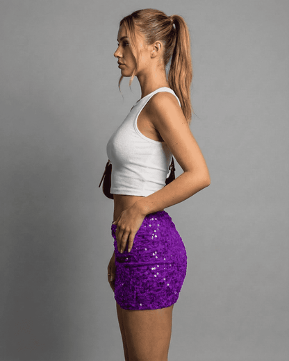 Lilith Mini Skirt by Slimona showcased on a model in profile, featuring a purple sequin design and high-waisted cut.