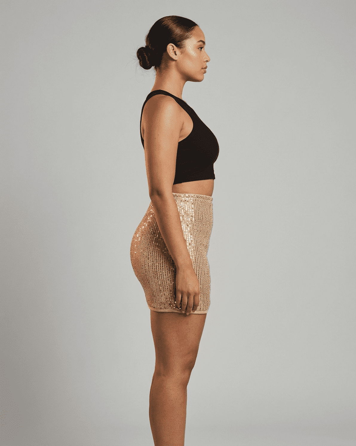 Lumiere Mini Skirt by Slimona - Sequin high waist bodycon mini skirt showcasing a side profile with a flattering fit.