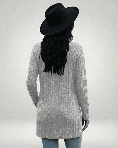 Back view of a model wearing the Luna Cardigan by Slimona, featuring a longline silhouette and ribbed knit texture.