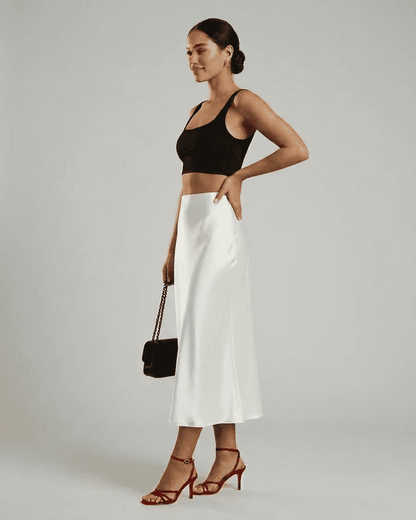 Model showcasing the Luna Midi Skirt by Slimona, featuring an elegant satin design and refined silhouette.