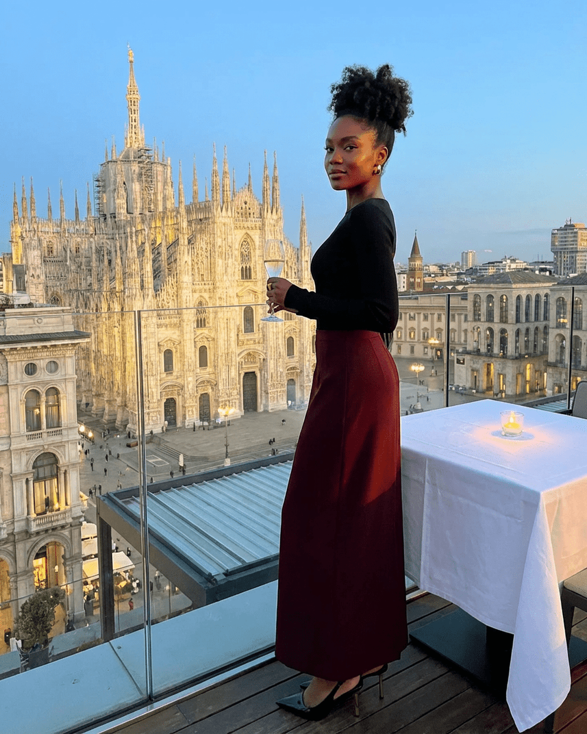 Merlot Maxi Skirt by Slimona worn by a woman with a stunning cityscape view in Milan.
