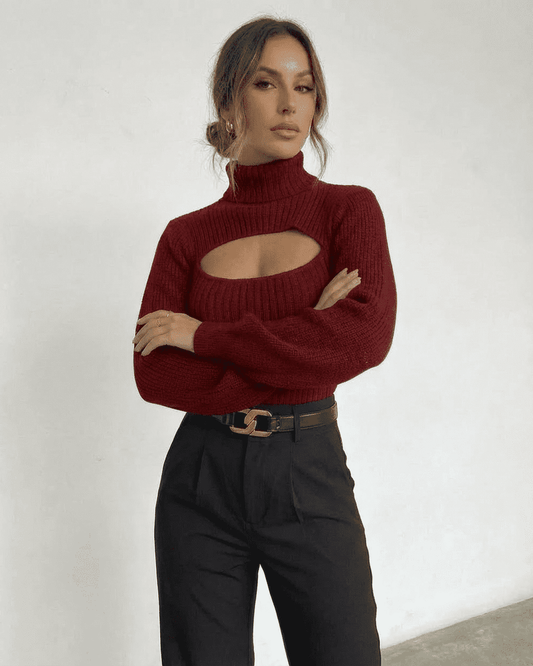 Elegant woman wearing a Slimona Merlot Sweater with a mock neck and cut out detail, paired with stylish black trousers.