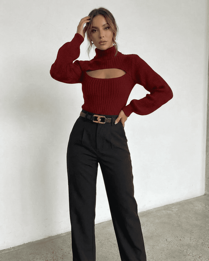 Model wearing a Merlot Sweater with mock neck and cut-out detail, styled with high-waisted pants.