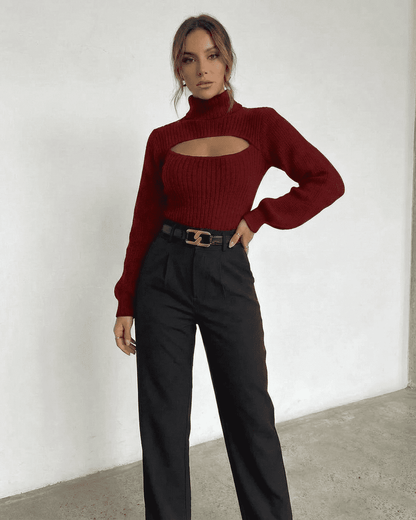 Merlot Sweater by Slimona featuring a mock neck and cut out design, styled with black trousers for a chic look.