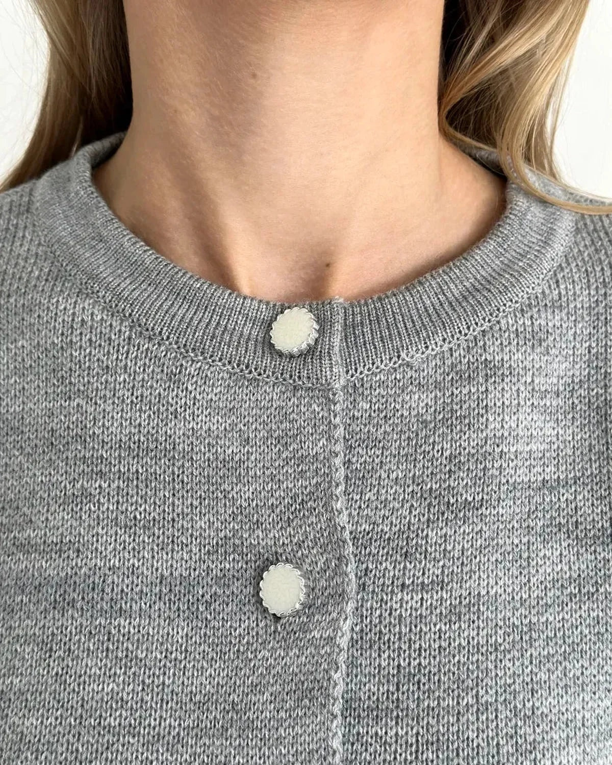 Mist Cardigan by Slimona, featuring a cozy gray knit texture and stylish button details, perfect for layering.