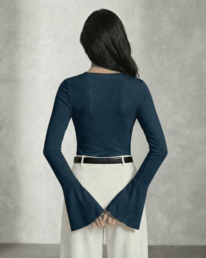 Nocturne Blouse by Slimona viewed from the back showcasing long sleeves and elegant bell cuffs.