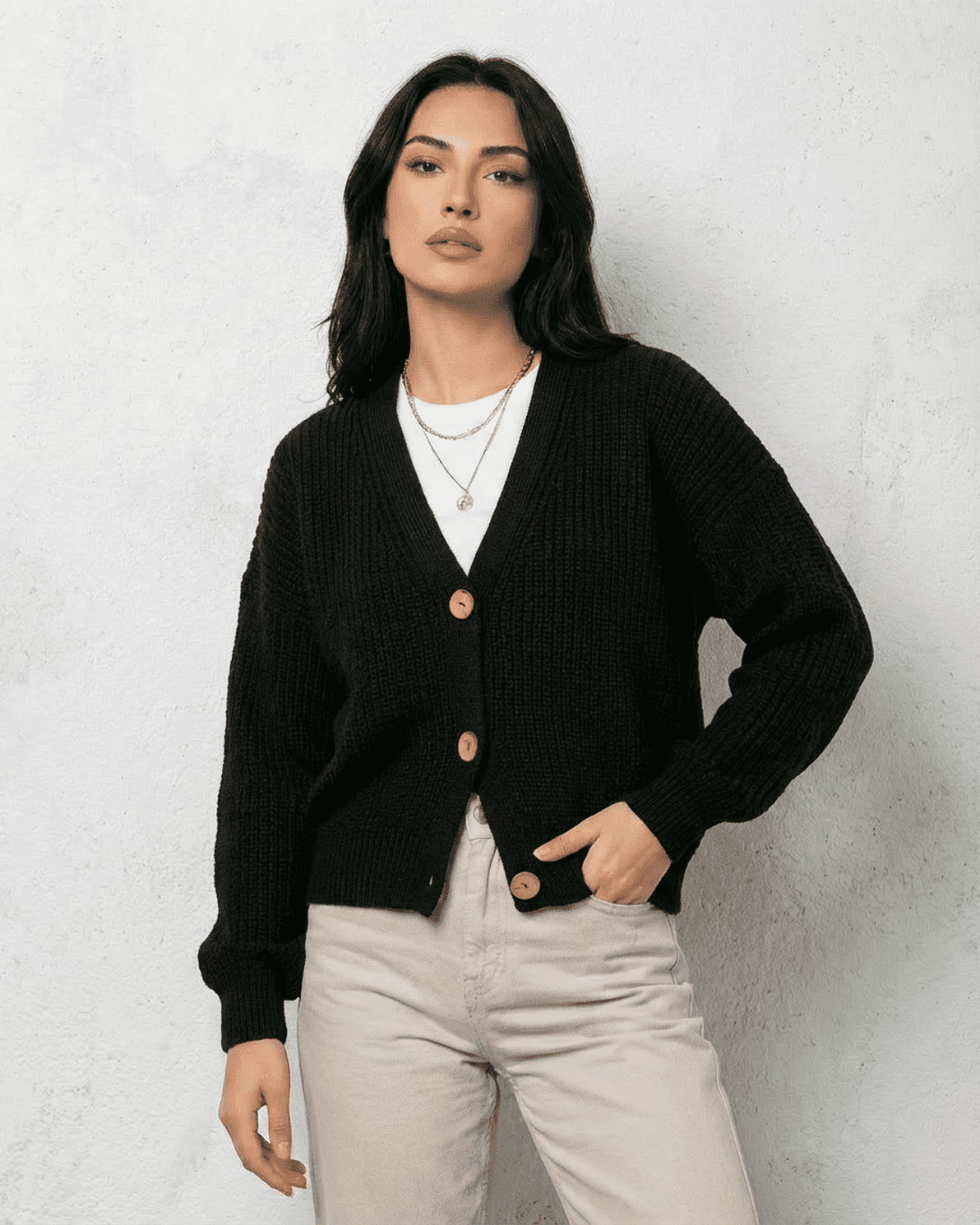 Noir Cardigan by Slimona – Stylish black knitwear with V-neck and button detail styled on a model.