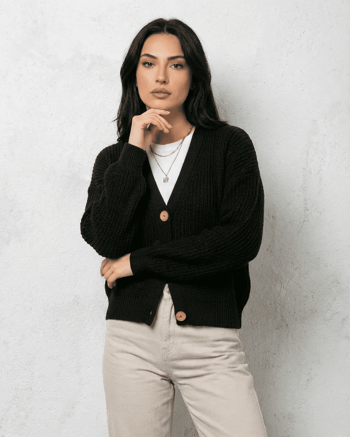 Noir Cardigan by Slimona – Stylish woman in a classic black cardigan with button detail and cozy fit.