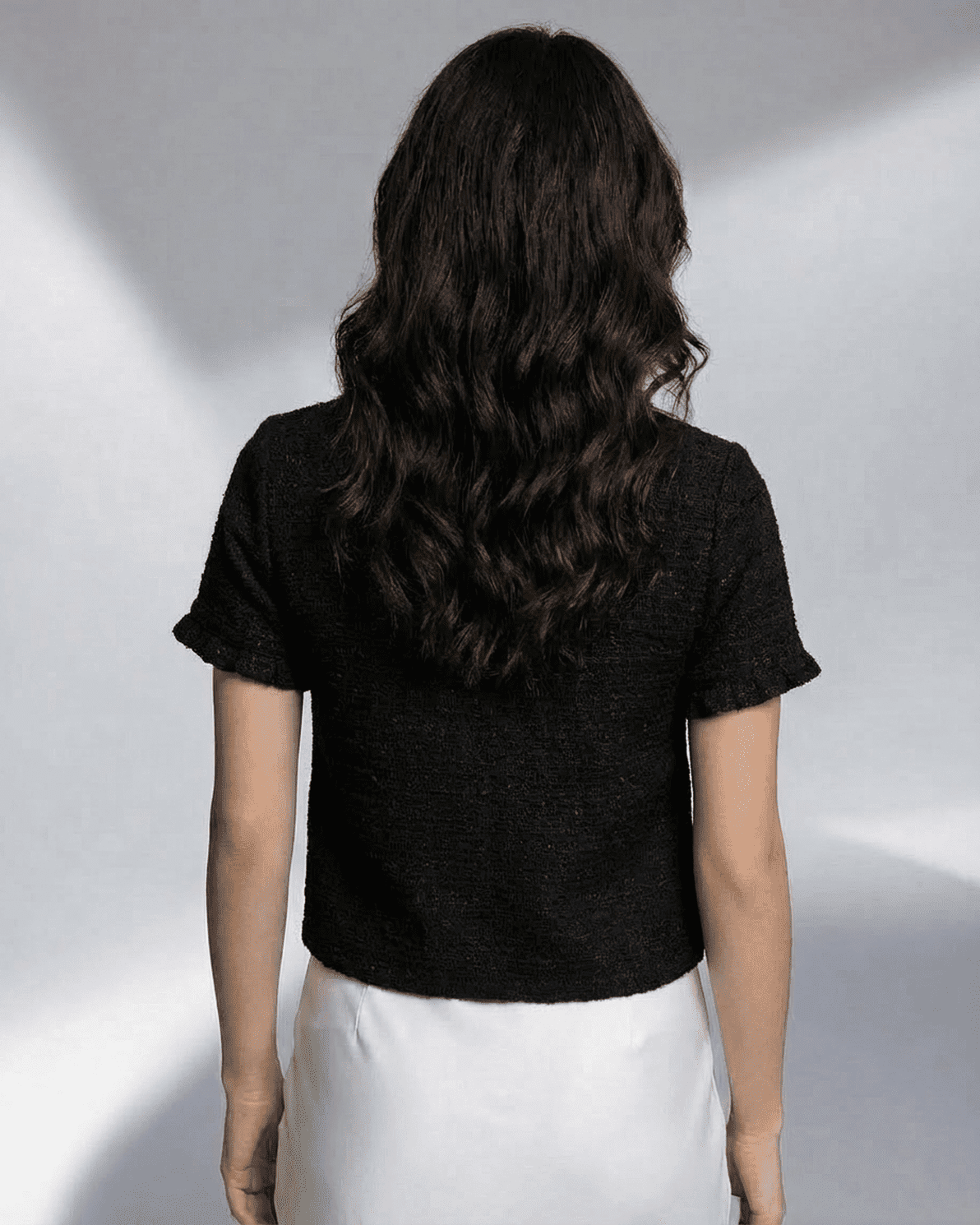 Noir Cardigan by Slimona, showcasing the back view of a short sleeve button knitwear with a clean silhouette.