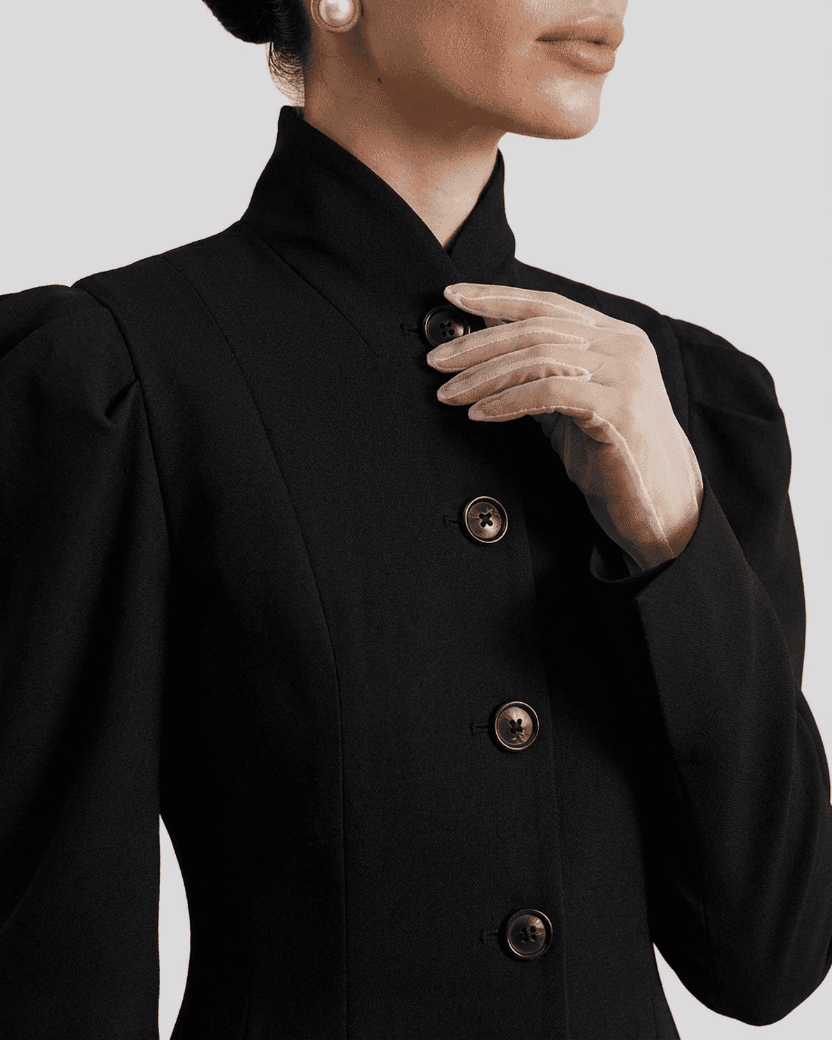 Elegant detail of the Noiré Blazer by Slimona, featuring a stand collar and structured puff sleeves.