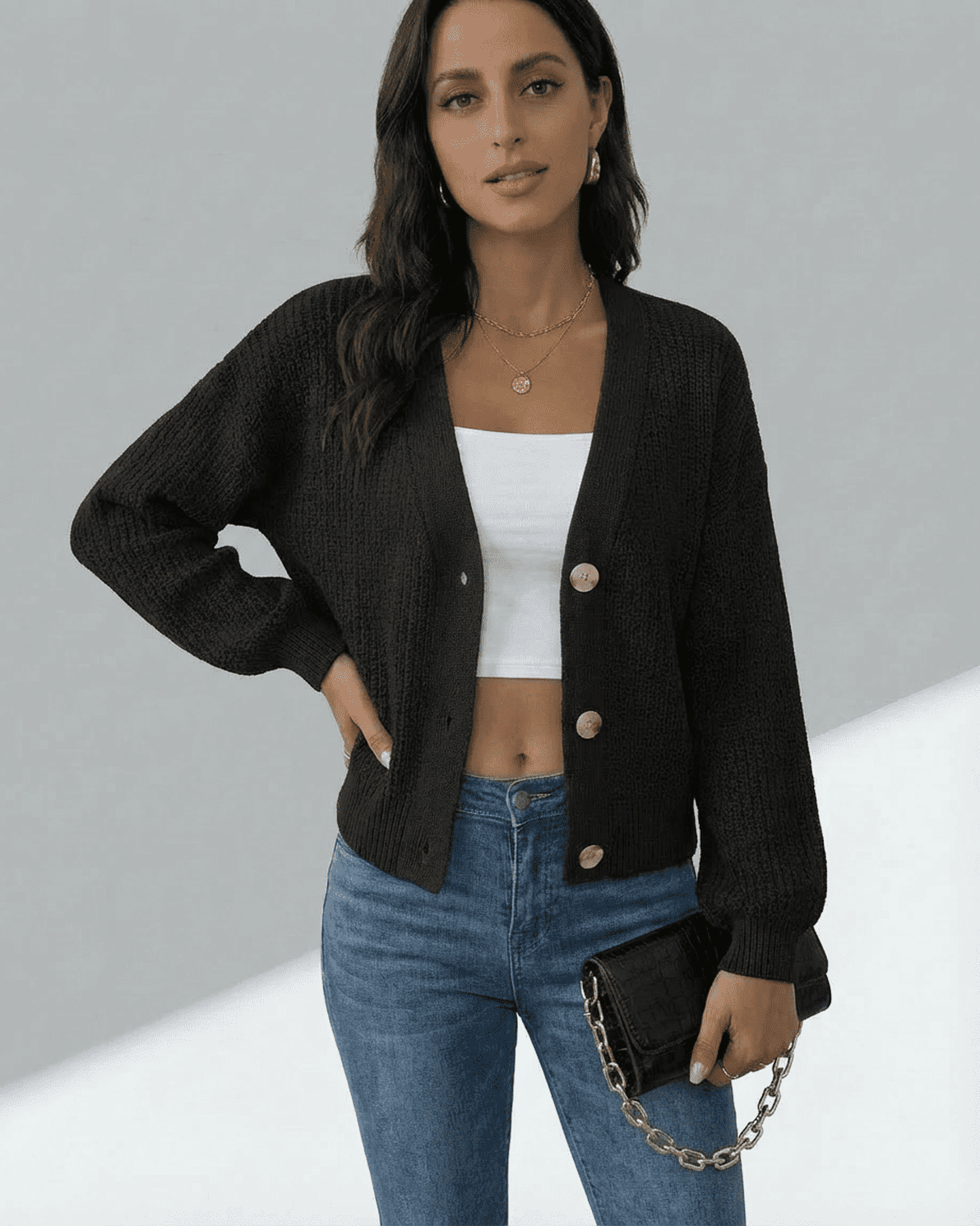 Model wearing the Slimona Orion Cardigan with a V-neckline, paired with jeans and a clutch.