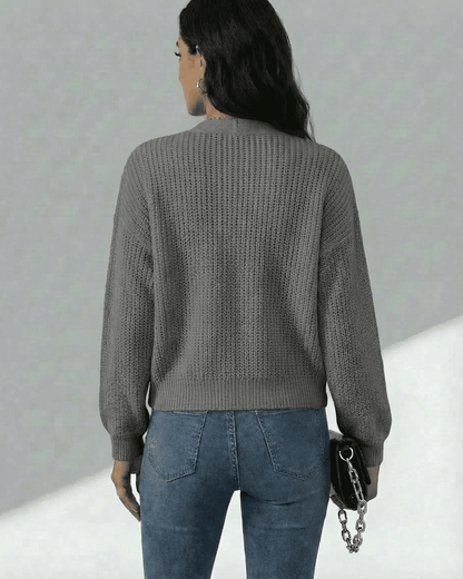 Rear view of a woman wearing the Slimona Orion Cardigan, showcasing its textured knit design and comfortable fit.