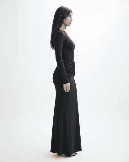 Orion Maxi Dress by Slimona featuring a long sleeve crew neck silhouette with ruched detail and a sleek black finish.