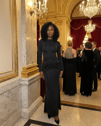 Orion Maxi Dress by Slimona, showcasing long sleeve crew neck silhouette with ruched high waist detail in elegant setting.