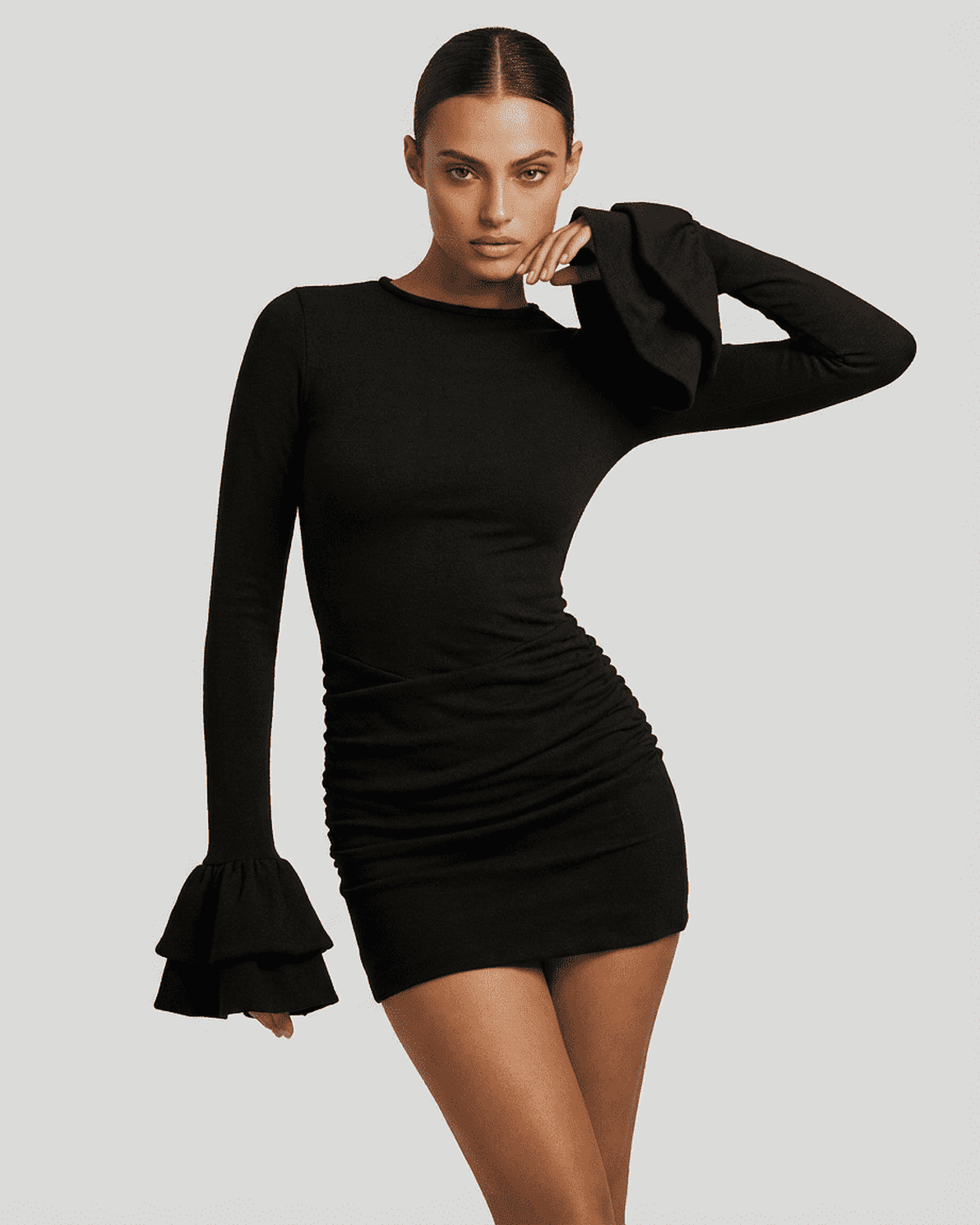 Model wearing the Orion Mini Dress by Slimona, showcasing ruffled sleeves and a flattering bodycon fit in black.