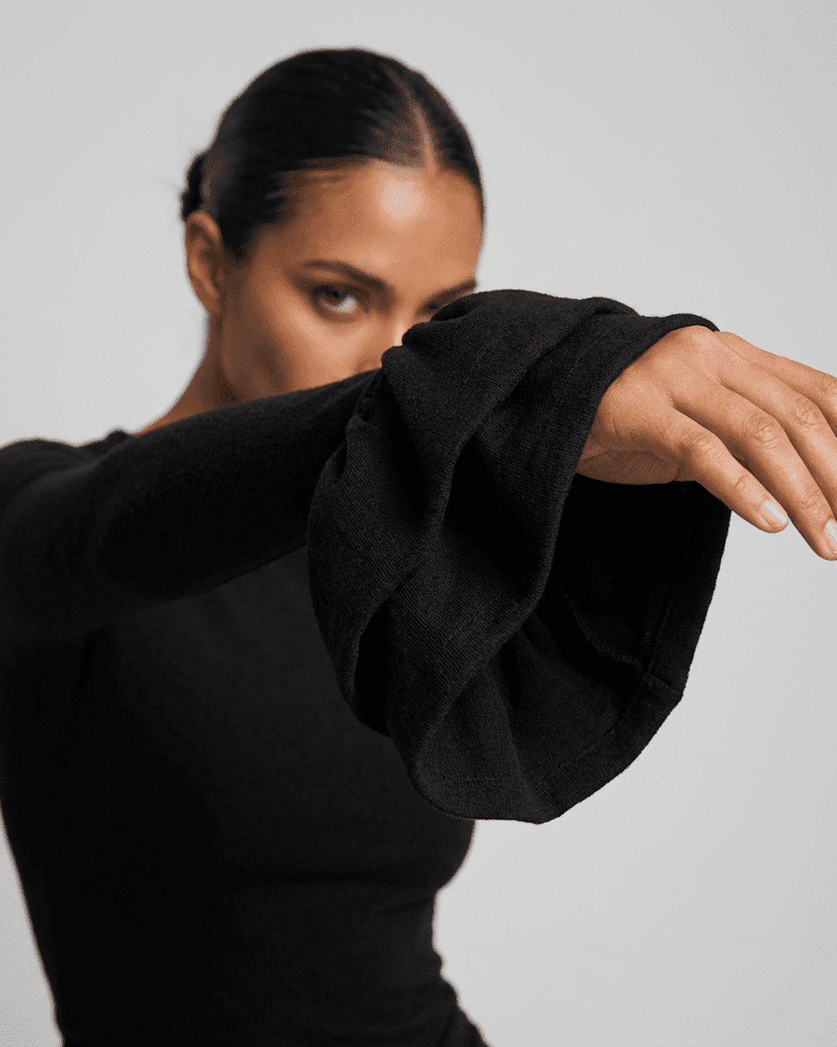 Orion Mini Dress by Slimona showcasing elegant ruffled sleeves and a sleek black design.