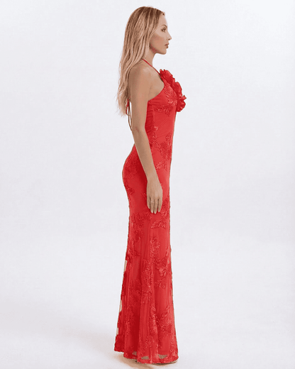 Rosalia Maxi Dress by Slimona, featuring a side view of a sleek red halter neck design with 3D floral appliqué detail.