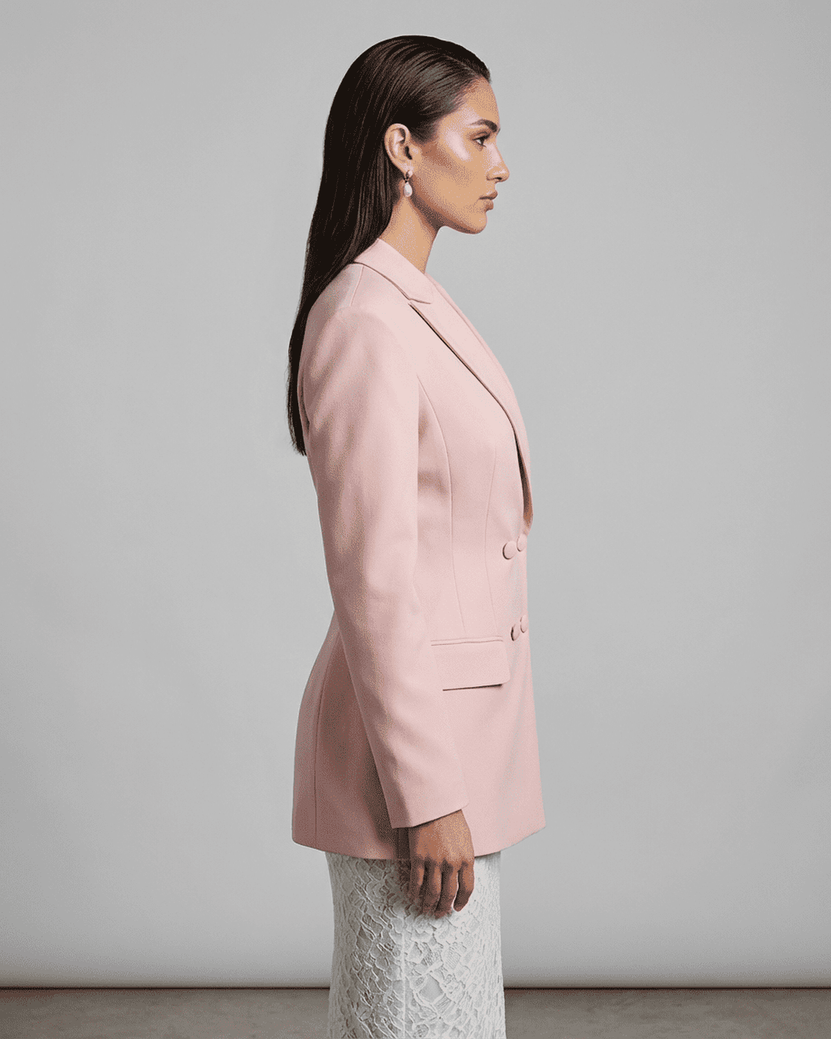 Side view of model wearing the elegant Rosalie Blazer by Slimona, showcasing its tailored silhouette in pink.