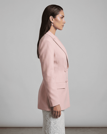 Side view of model wearing the elegant Rosalie Blazer by Slimona, showcasing its tailored silhouette in pink.