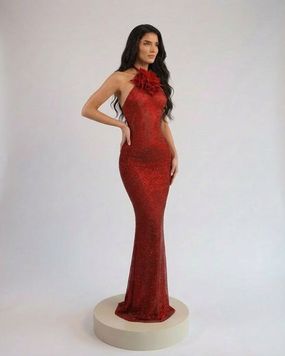 Scarlet Maxi Dress by Slimona featuring a sleek halter neck and floral details in a rich red shimmer.