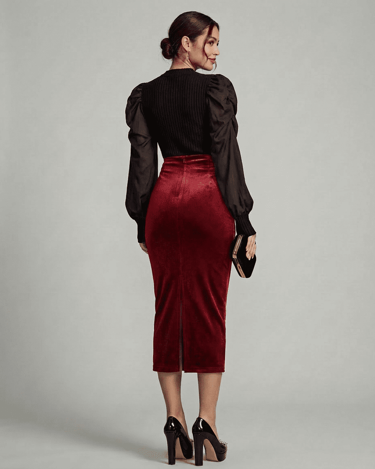 Elegant back view of a model wearing the Slimona Scarlet Midi Skirt, showcasing its rich velvet fabric and high waist design.