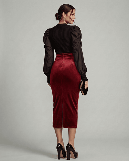 Elegant back view of a model wearing the Slimona Scarlet Midi Skirt, showcasing its rich velvet fabric and high waist design.
