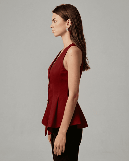 Scarlett Blouse by Slimona, elegant satin sleeveless top in rich red with tailored peplum silhouette.