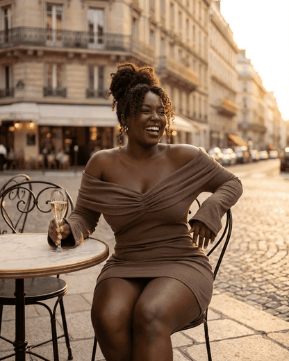 Selene Mini Brown - Off Shoulder V Neck Knit Waist Slim A Line Mini Dress by Slimona worn by a woman enjoying a drink.