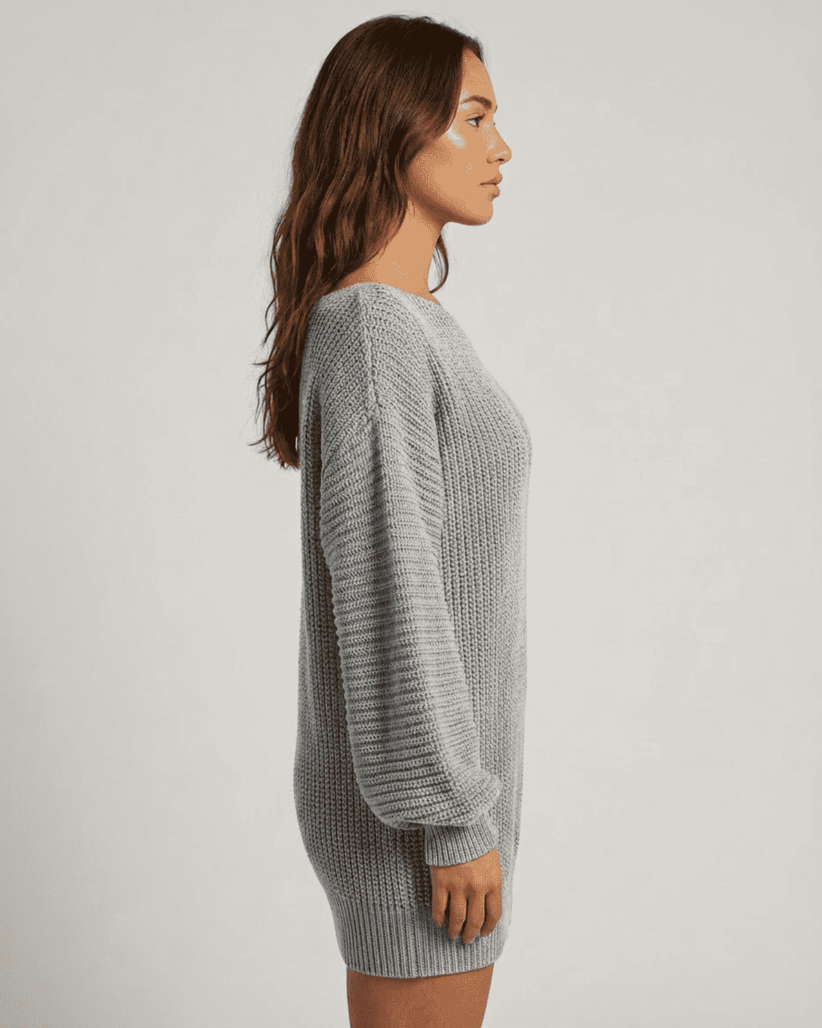 Selene Mini Dress by Slimona in grey ribbed knit with off-the-shoulder lantern sleeves styled in a side profile view.